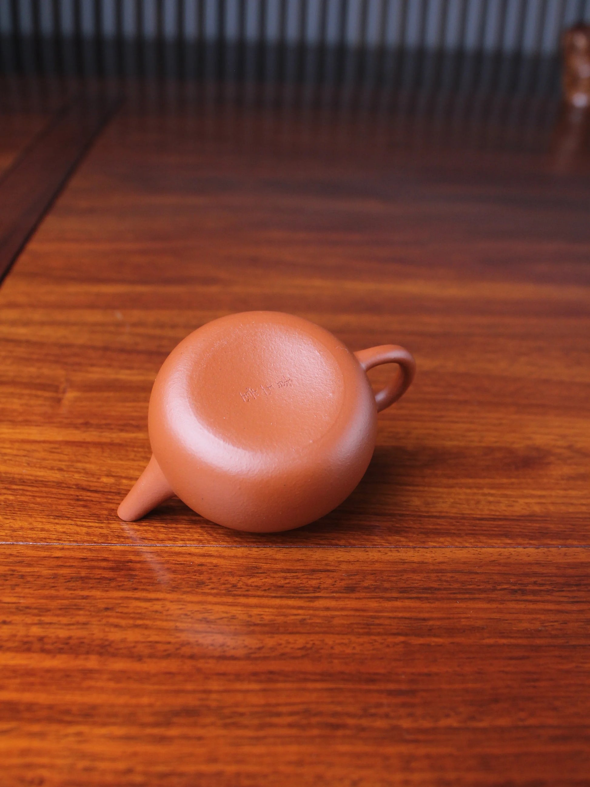 the bottom of the handmade yixing teapot pao zun on the table