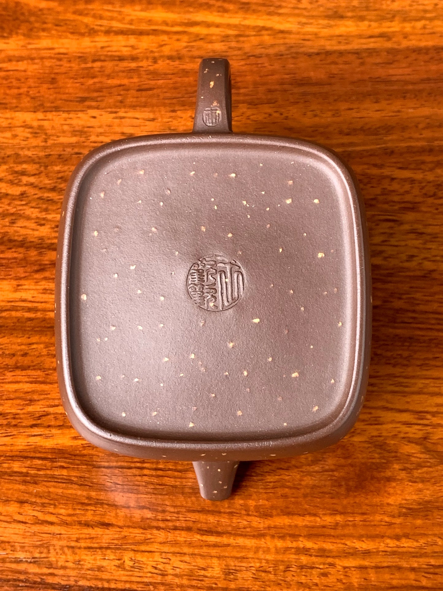 Looking down at the teapot, there are two yixing teapot marks on the bottom.