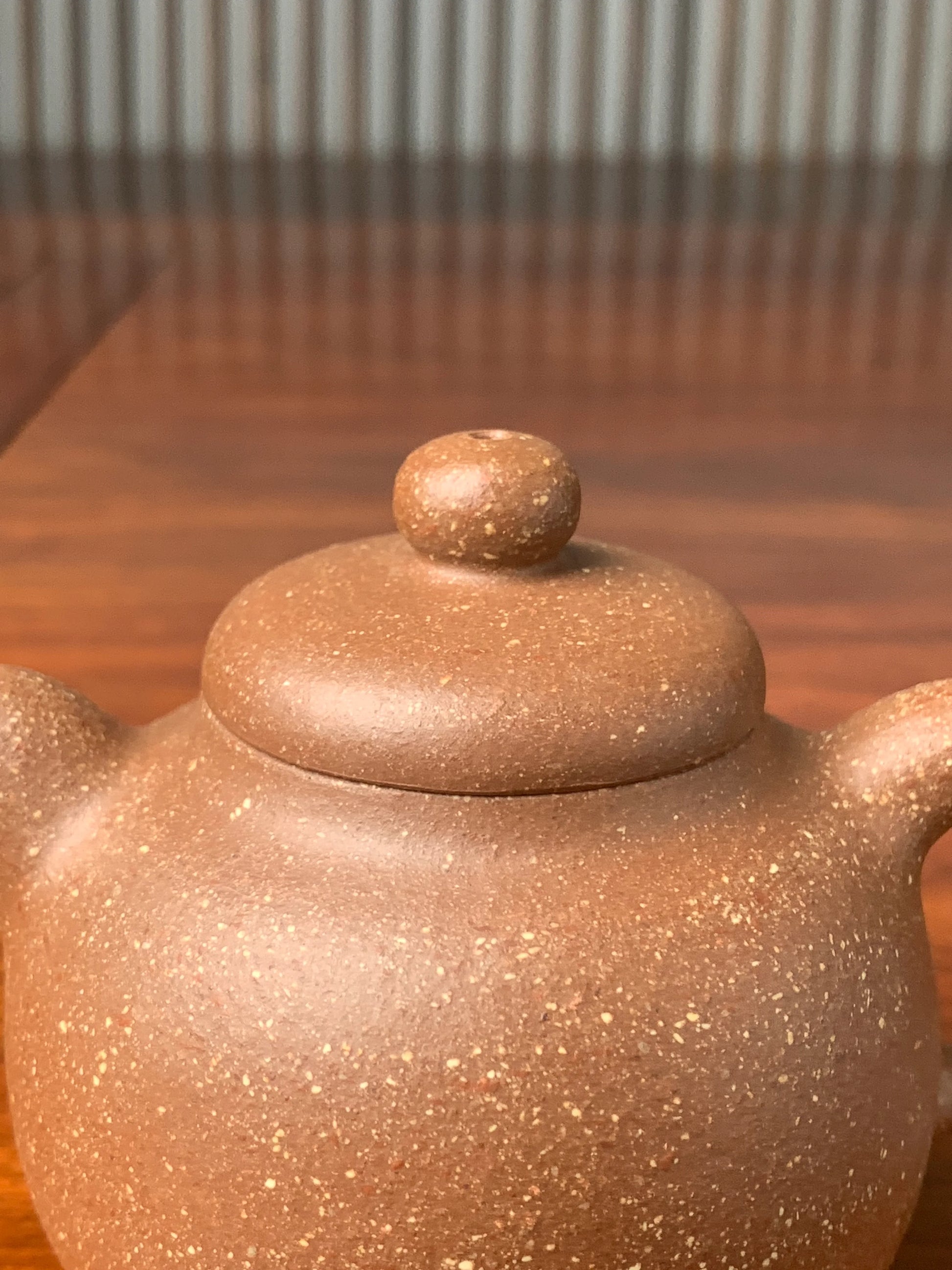 the lid of the handmade yixing teapot on the table