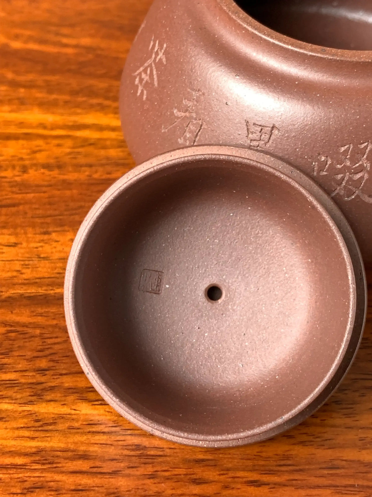 A close look at the seal of art master Qian Xiaojun inside the teapot