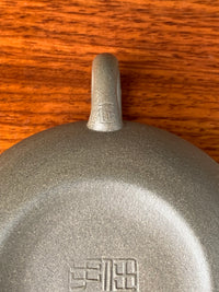 The seal of the artist Jing Ren on the teapot handle.
