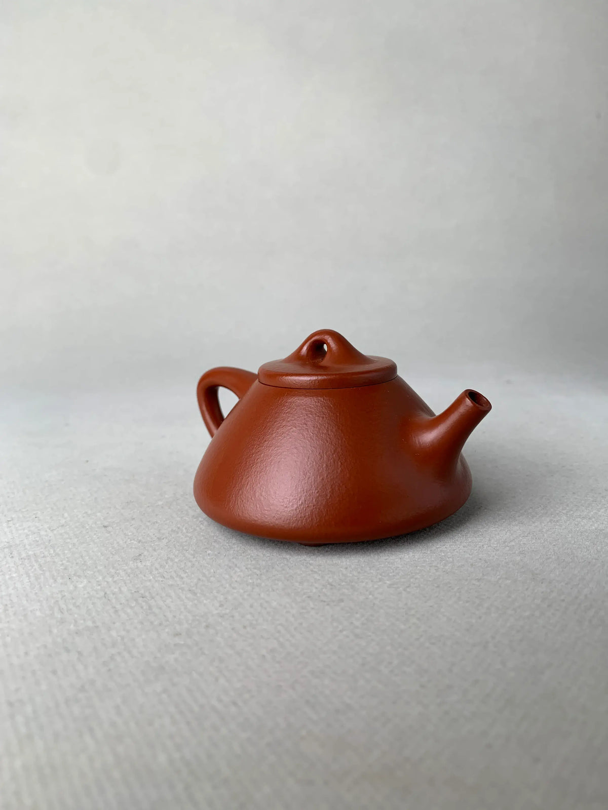 the right view of the yixing teapot zisha shi piao on the table