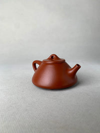 the right view of the yixing teapot zisha shi piao on the table