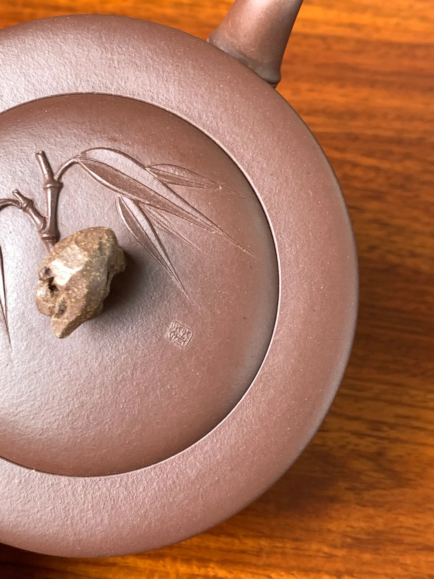 Overhead view showing the teapot lid and the details of the seal impressed on it