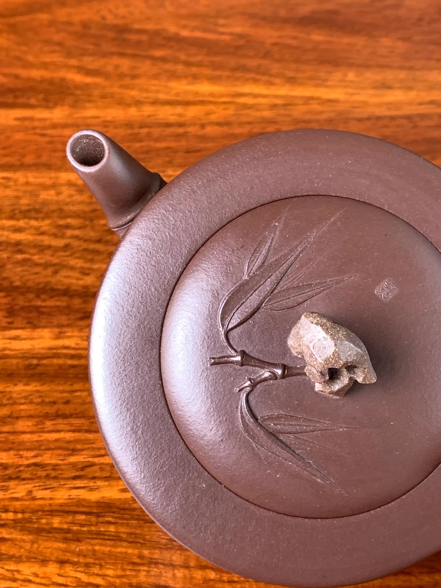 Looking down at the details of the collectible teapot lid and spout
