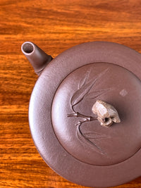 Looking down at the details of the collectible teapot lid and spout