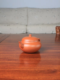 right of the yi shing teapot handmade with zisha zhu ni