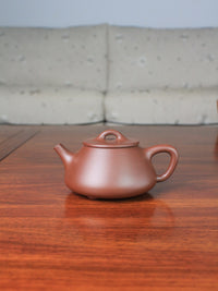 Front view of yi shing teapot shi piao handmade with yixing zisha