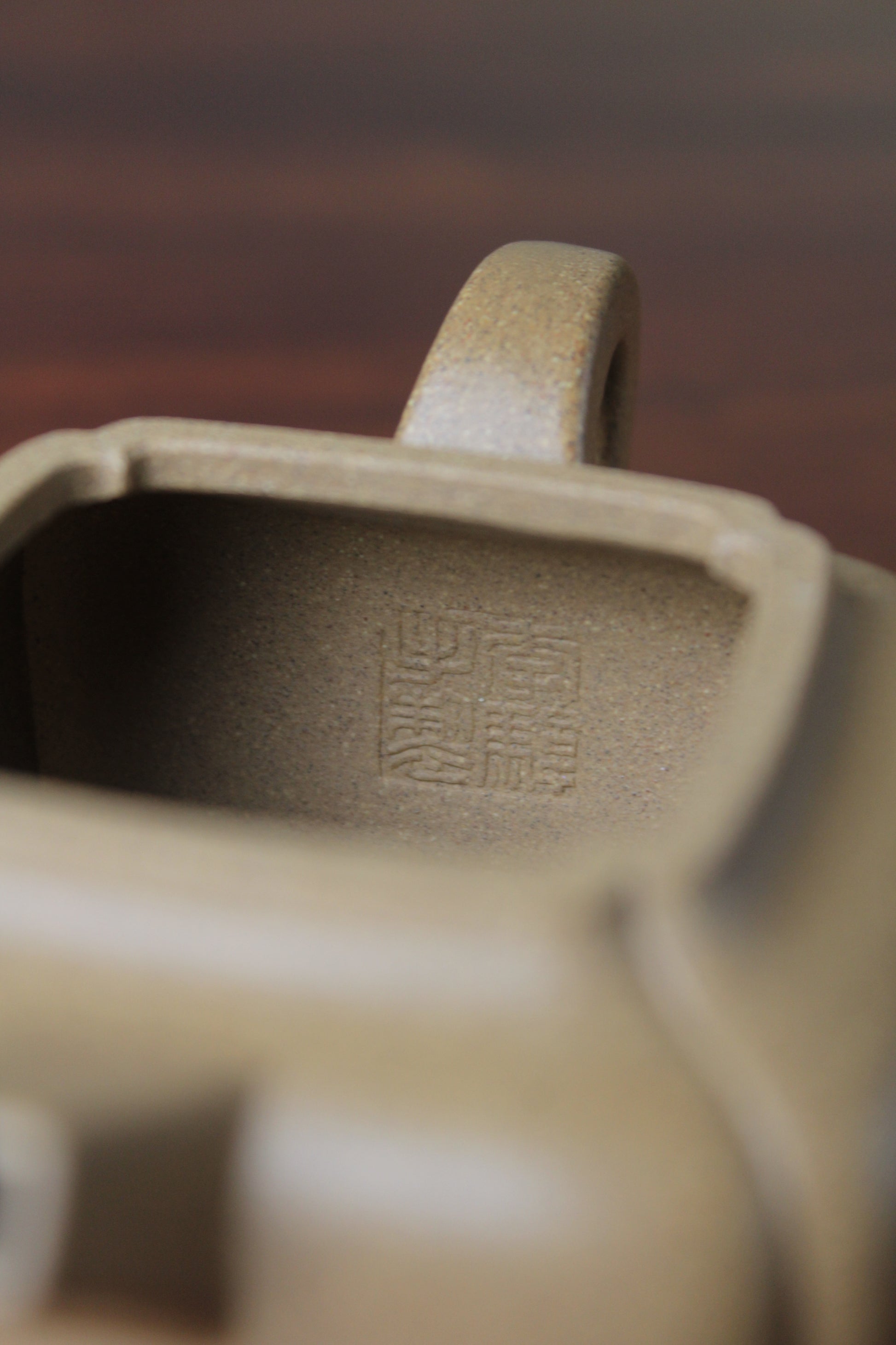 Inside mark of the yi xing tea pot handmade with purple clay on the table