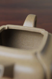 Inside mark of the yi xing tea pot handmade with purple clay on the table