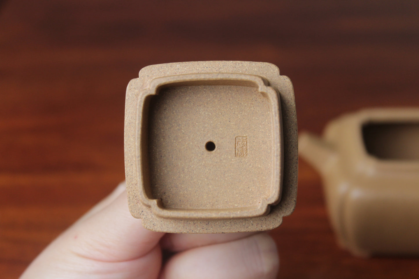 lid mark of yi xing tea pot handmade with purple clay on the table