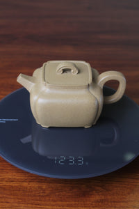 weight of the yi xing tea pot handmade with purple clay on the table