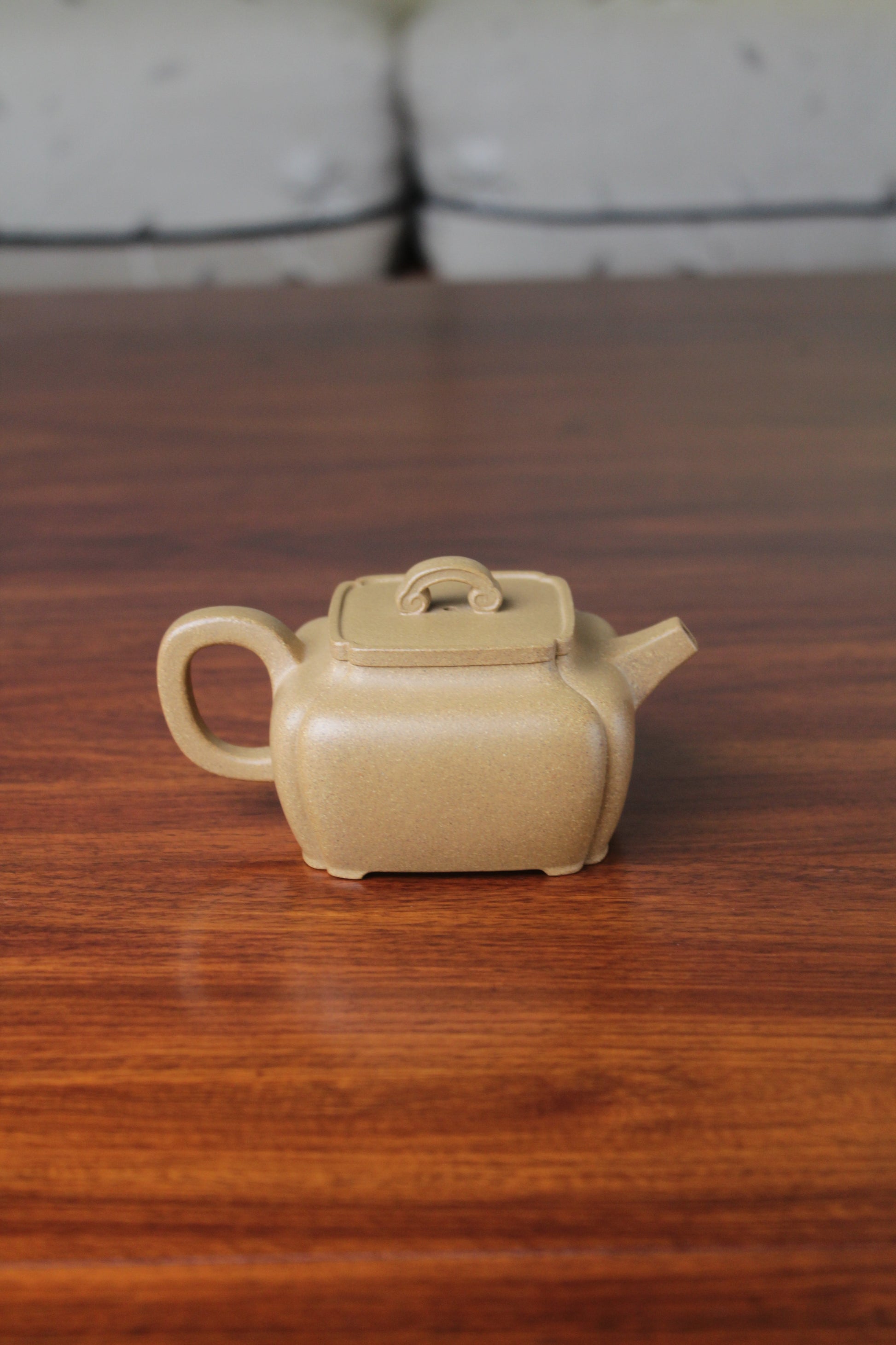 Back of the yi xing tea pot handmade with purple clay on the table