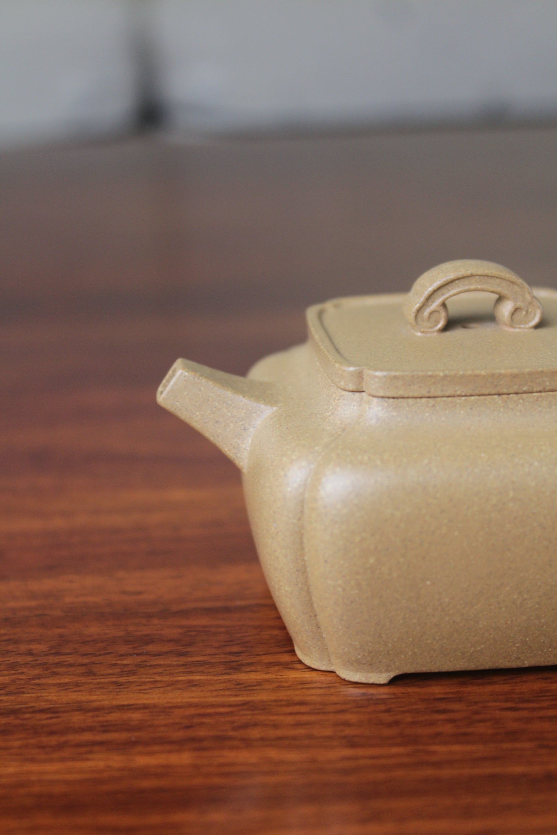 Spout of the yi xing tea pot handmade with purple clay on the table