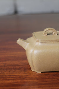 Spout of the yi xing tea pot handmade with purple clay on the table