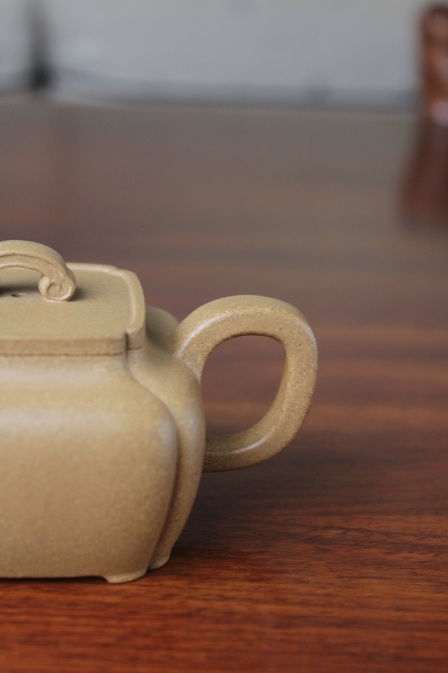 Handle of the yi xing tea pot handmade with purple clay on the table
