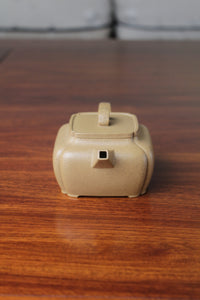 Spout detail of the yi xing tea pot handmade with purple clay on the table