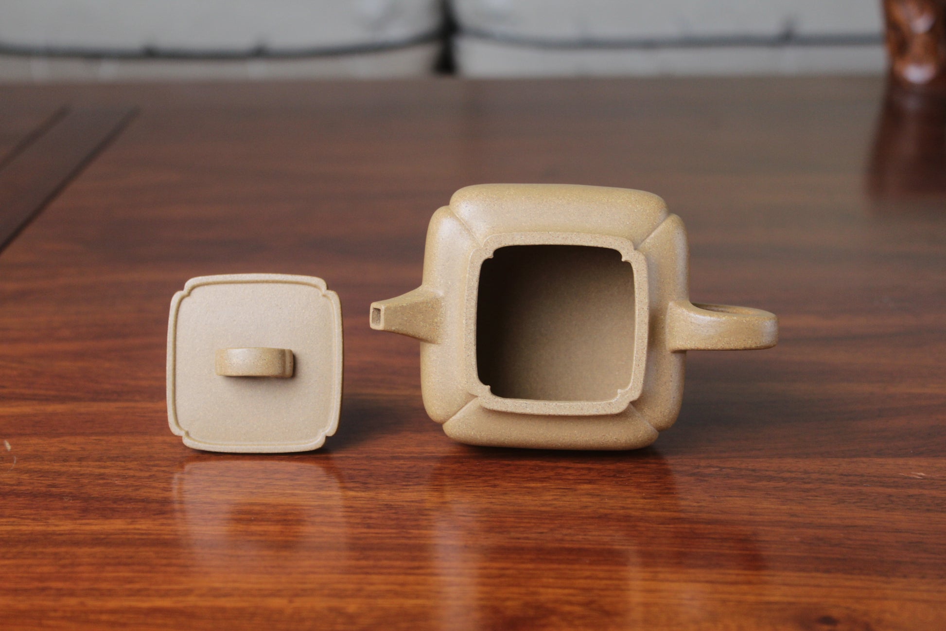 two details of yi xing tea pot handmade with purple clay on the table