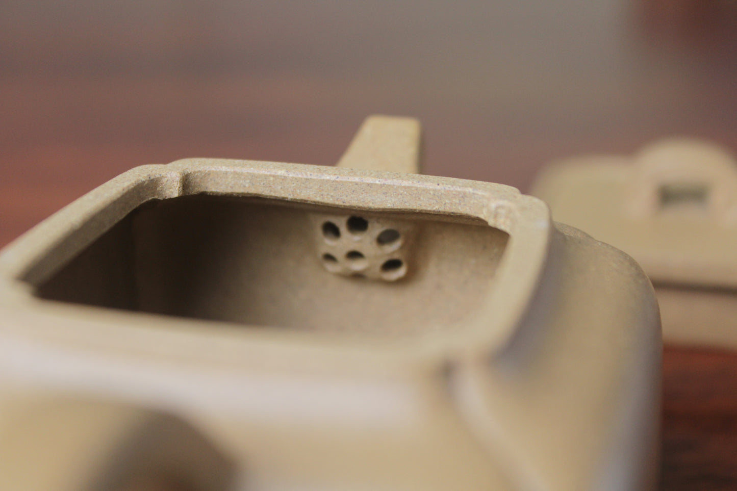 Filter of the yi xing tea pot handmade with purple clay on the table