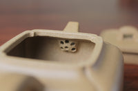 Filter of the yi xing tea pot handmade with purple clay on the table