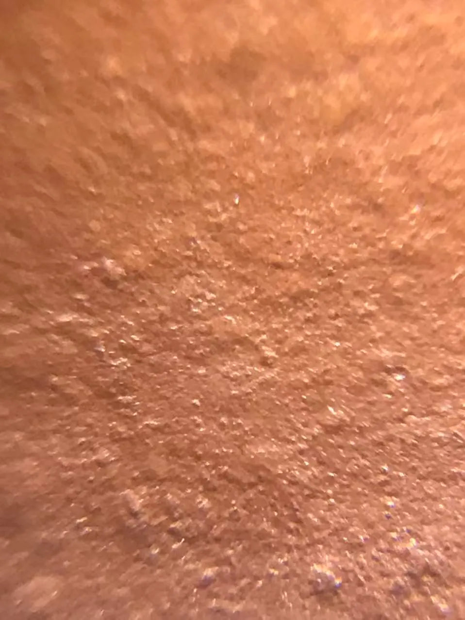 A magnified photo of the teapot’s raw material: premium zhuni clay.