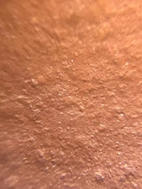 A magnified photo of the teapot’s raw material: premium zhuni clay.