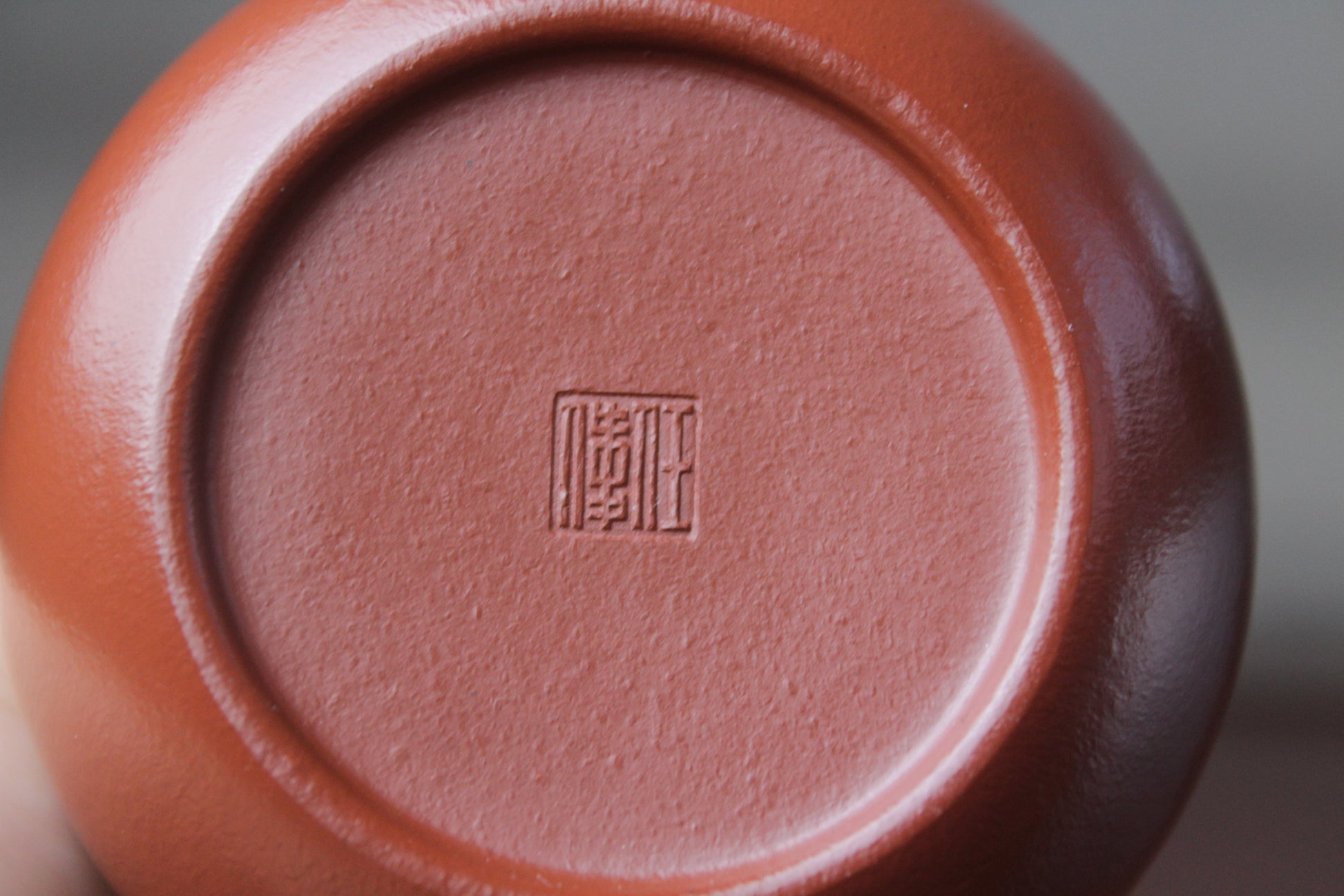 Bottom detail of the yixing clay teapot xishi on the table
