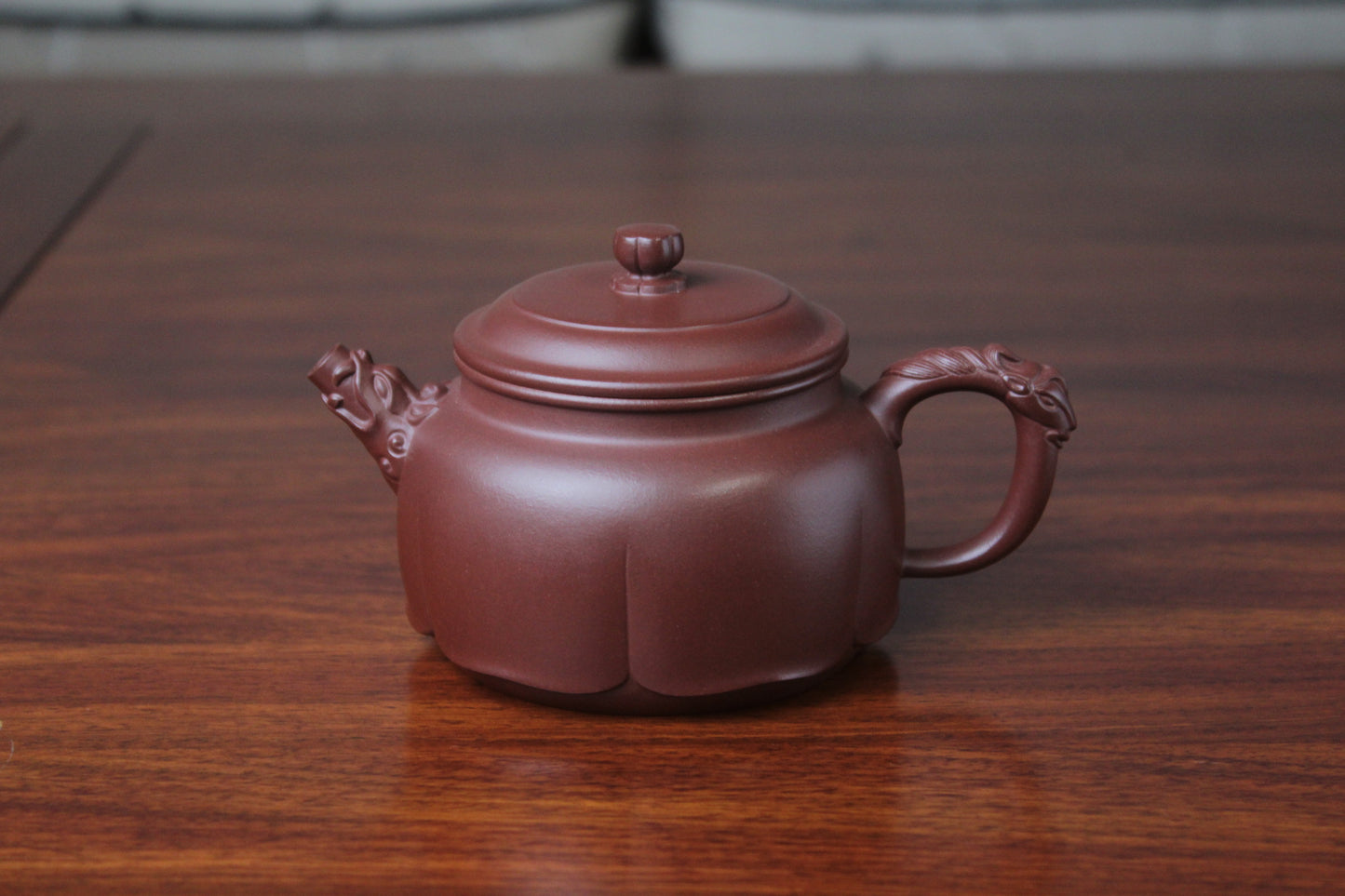 The front detail of the yixing clay teapot on the table
