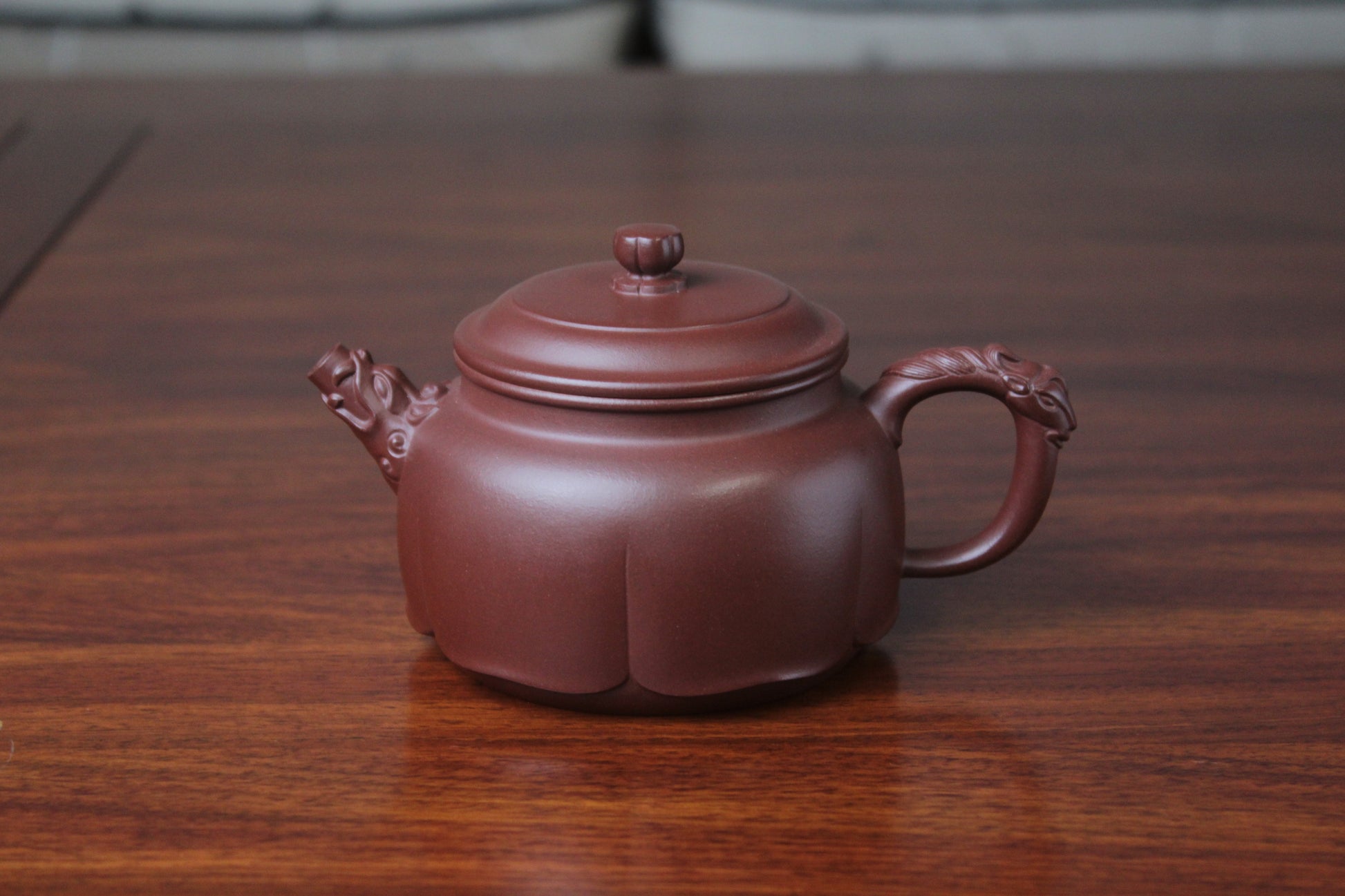 The front detail of the yixing clay teapot on the table