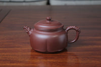 The front detail of the yixing clay teapot on the table