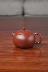 Front view of the yixing clay teapot xishi on the table