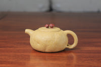 The front detail of the yixing clay teapot on the table