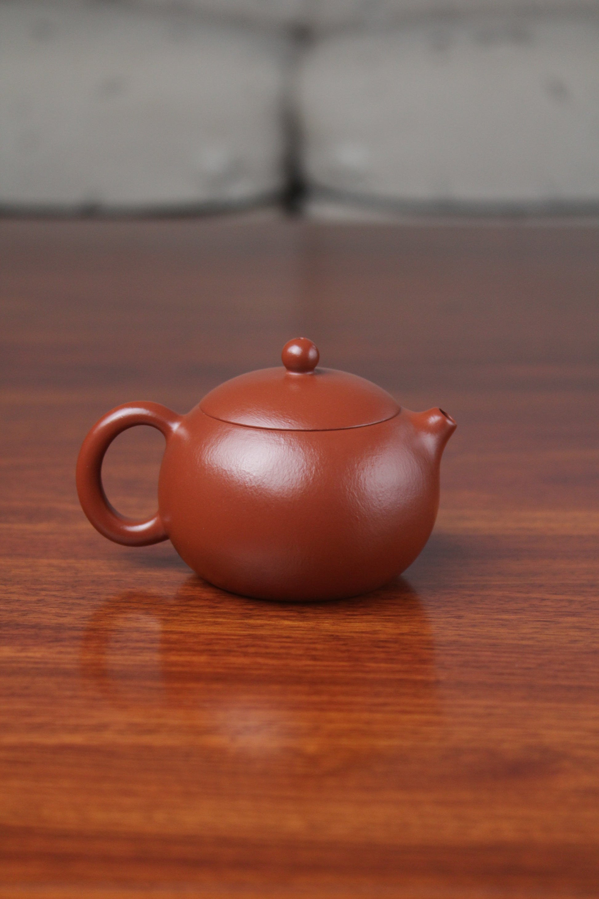 Back view of the yixing clay teapot xishi on the table