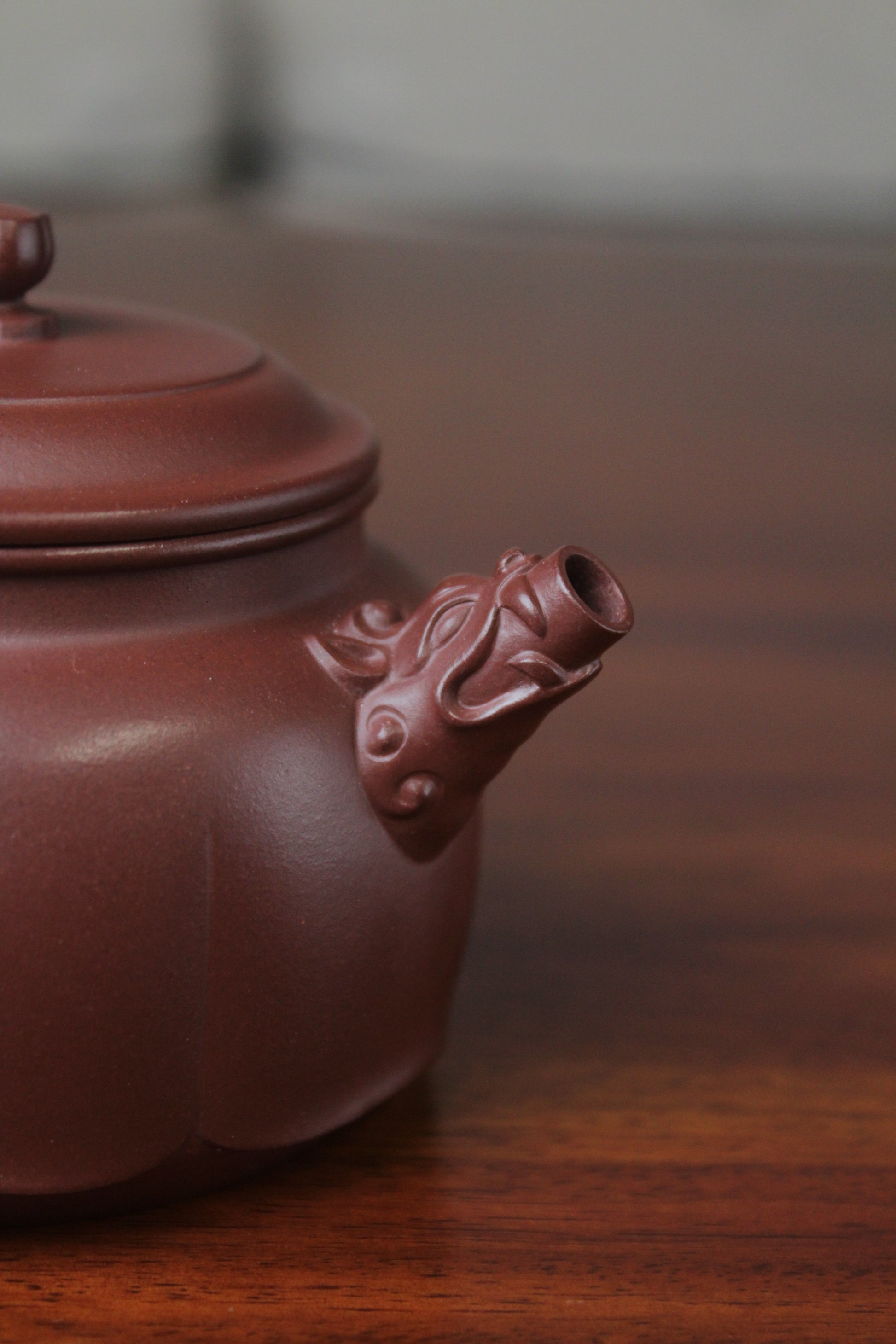 The spout of the yixing clay teapot on the table