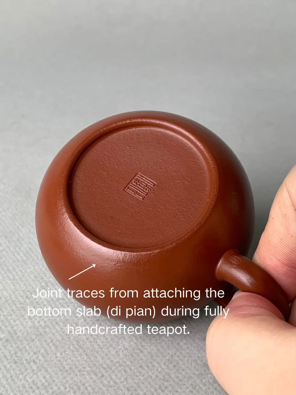 Joint traces from attaching the bottom slab (di pian) during fully handcrafted teapot.