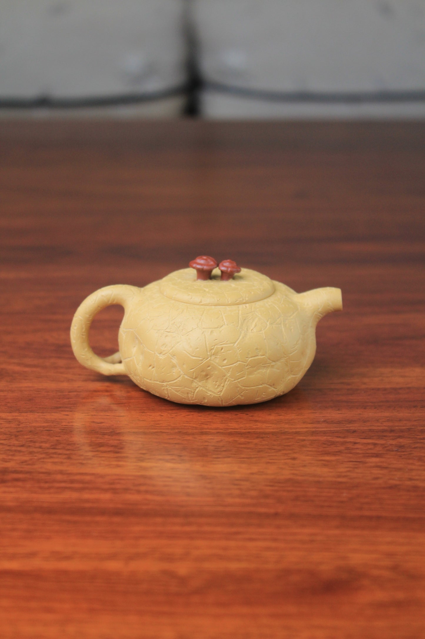 The back of the yixing clay teapot on the table