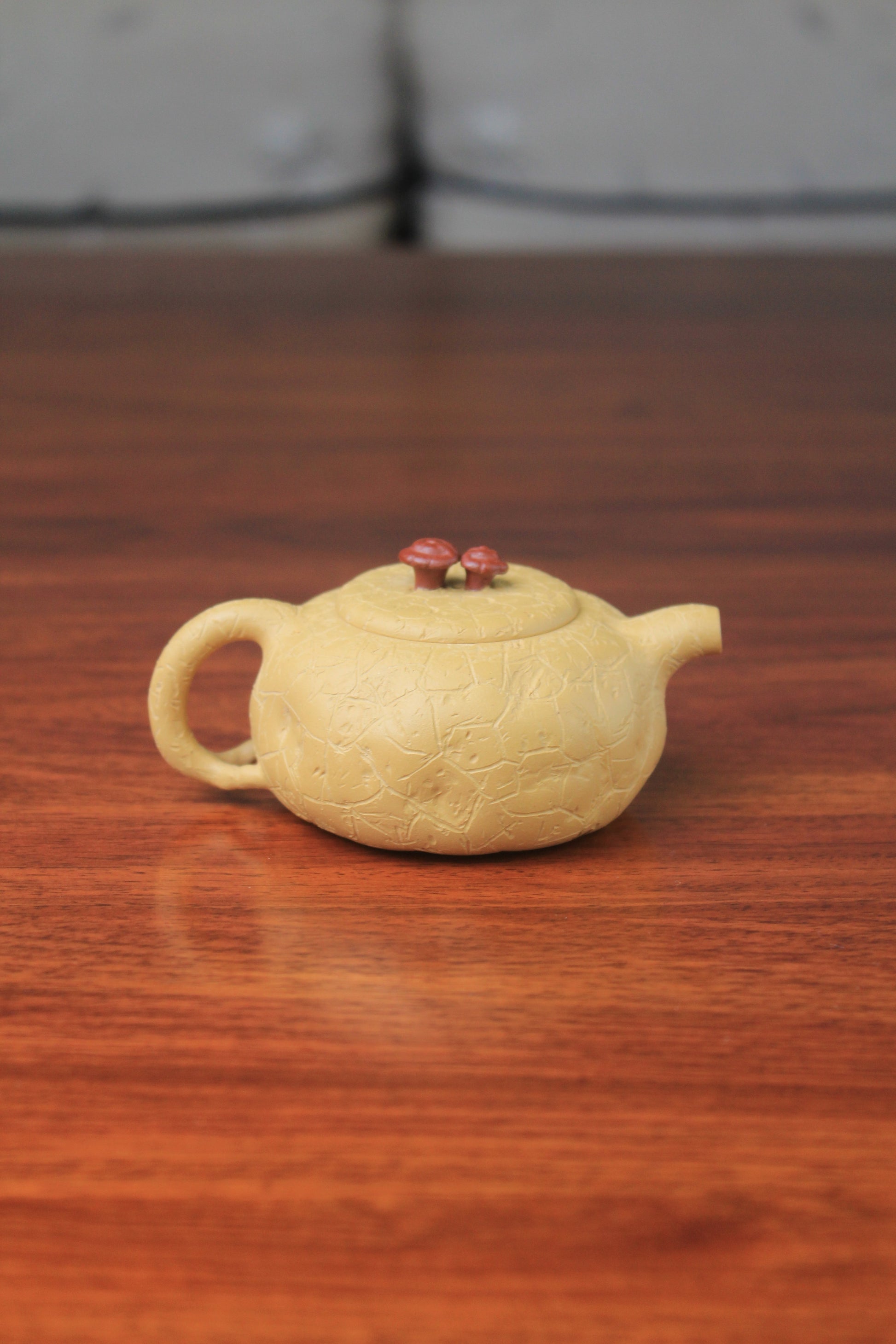 The back of the yixing clay teapot on the table