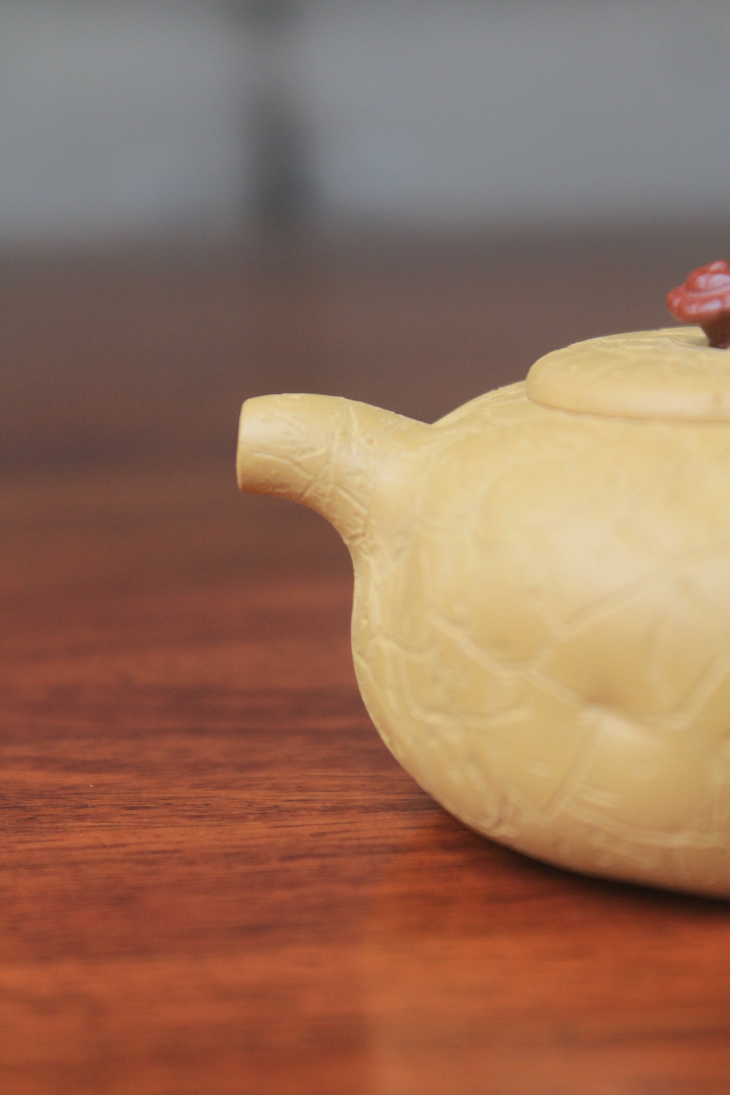 The spout of the yixing clay teapot on the table