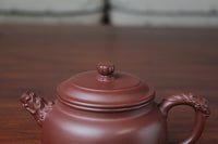 The lid detail of the yixing clay teapot on the table