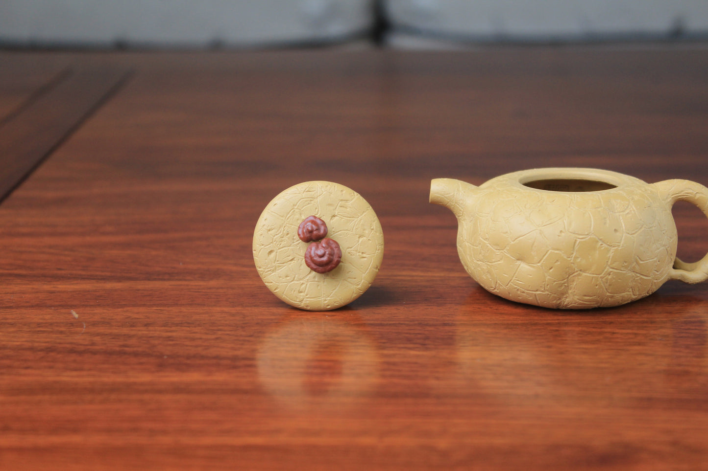 The 2 details of the yixing clay teapot on the table