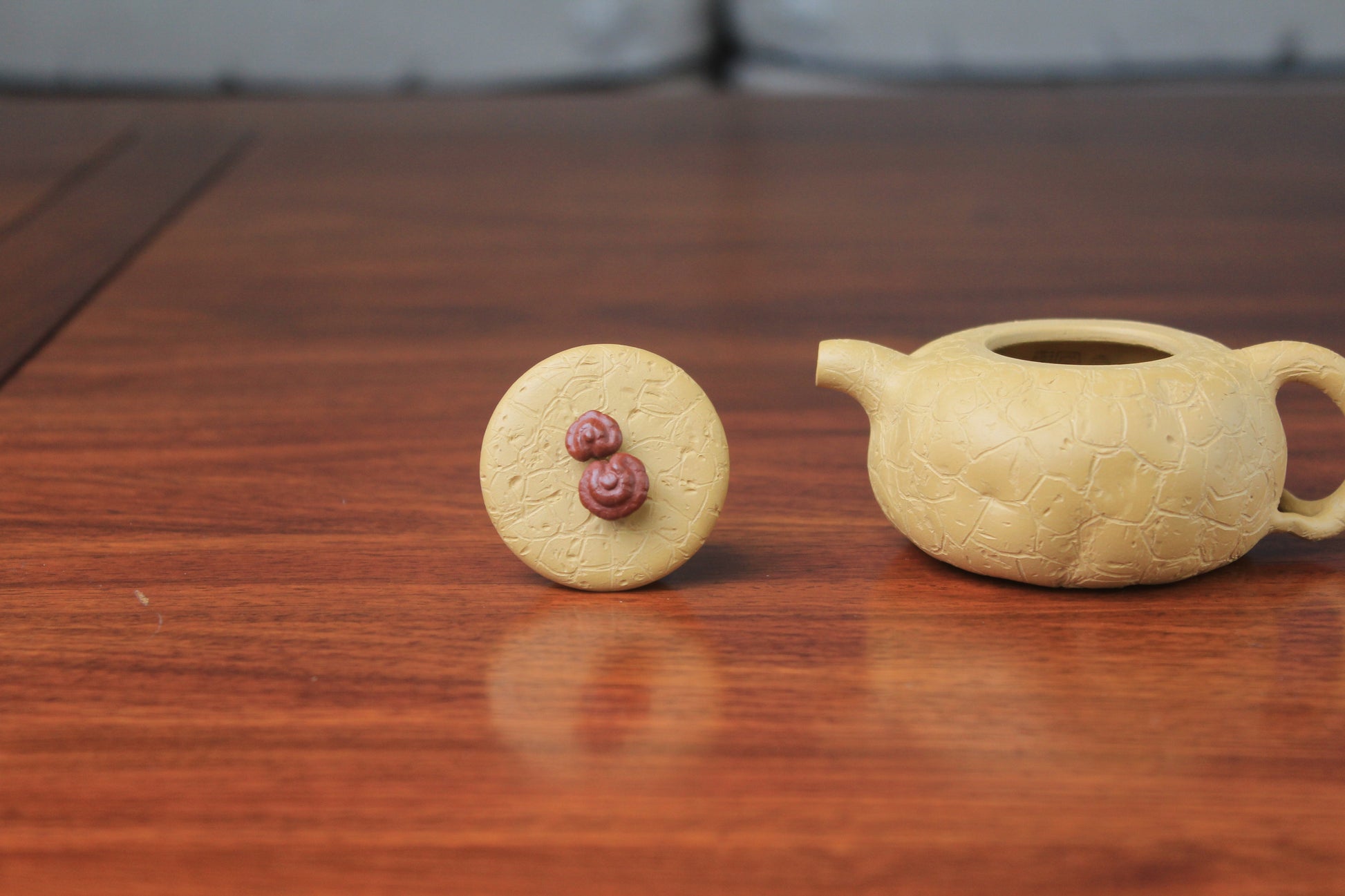 The 2 details of the yixing clay teapot on the table
