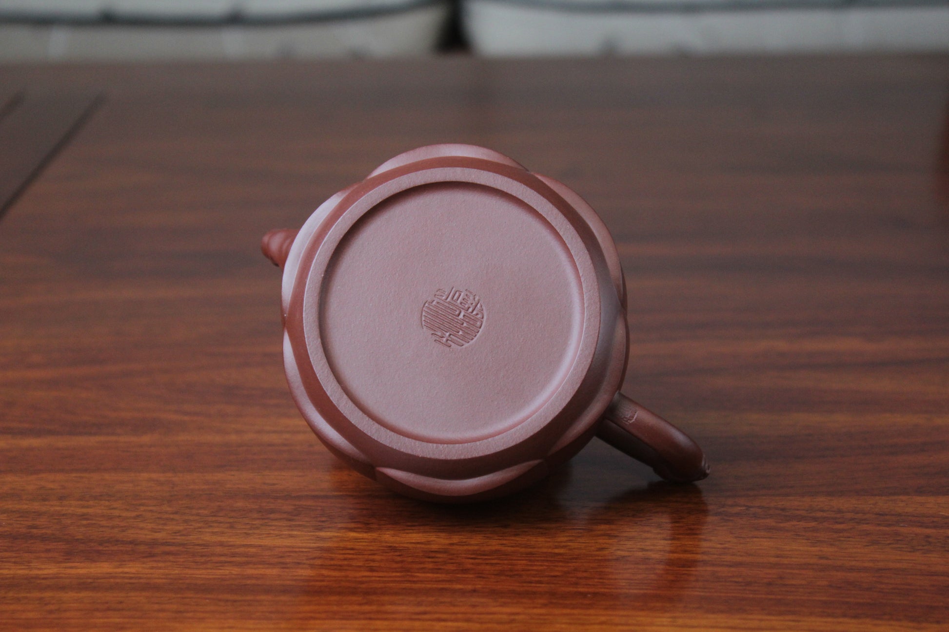 The bottom of the yixing clay teapot on the table