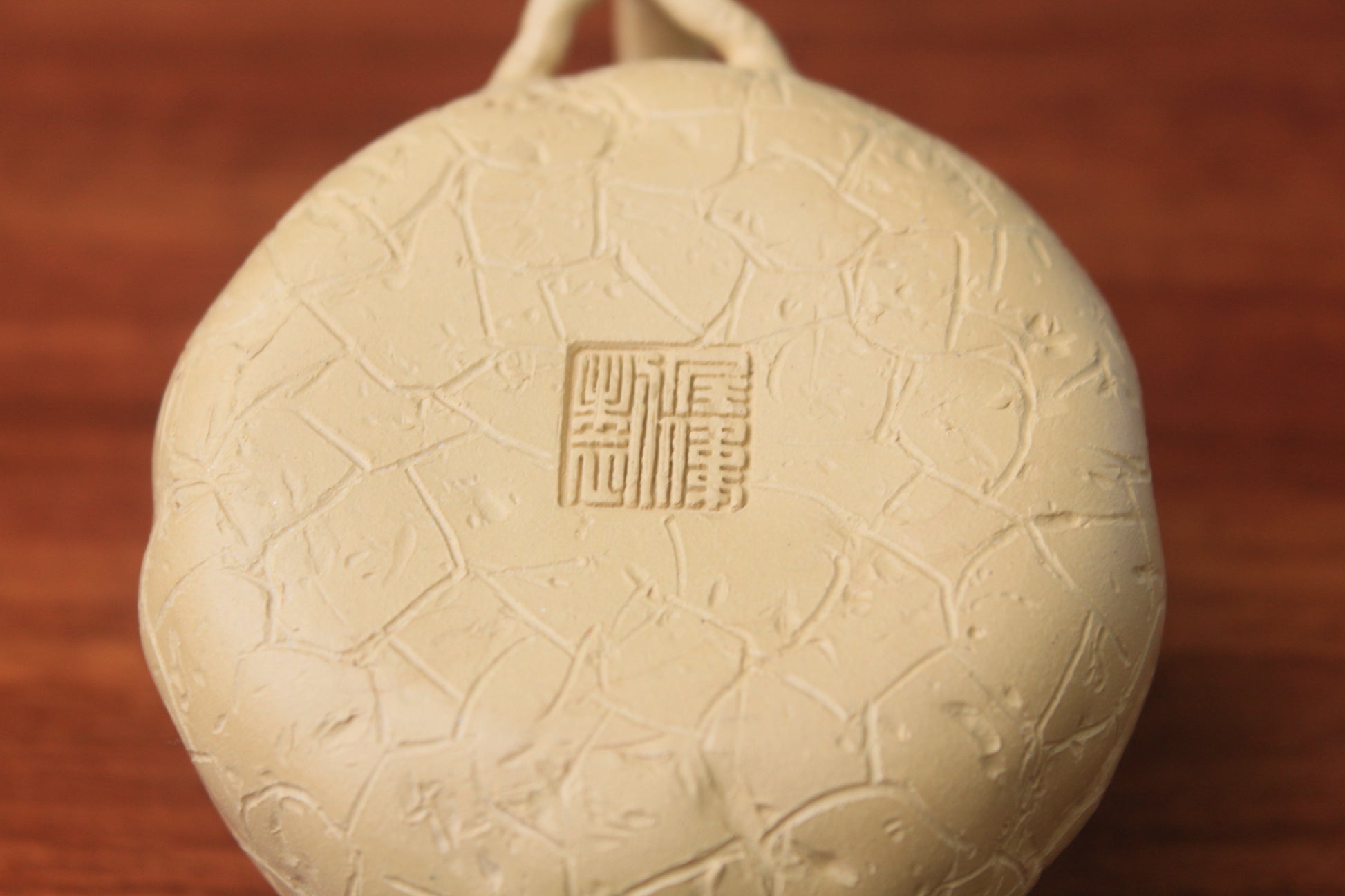 The bottom mark of the yixing clay teapot on the table