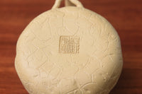 The bottom mark of the yixing clay teapot on the table