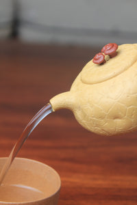 The pour of the yixing clay teapot on the table