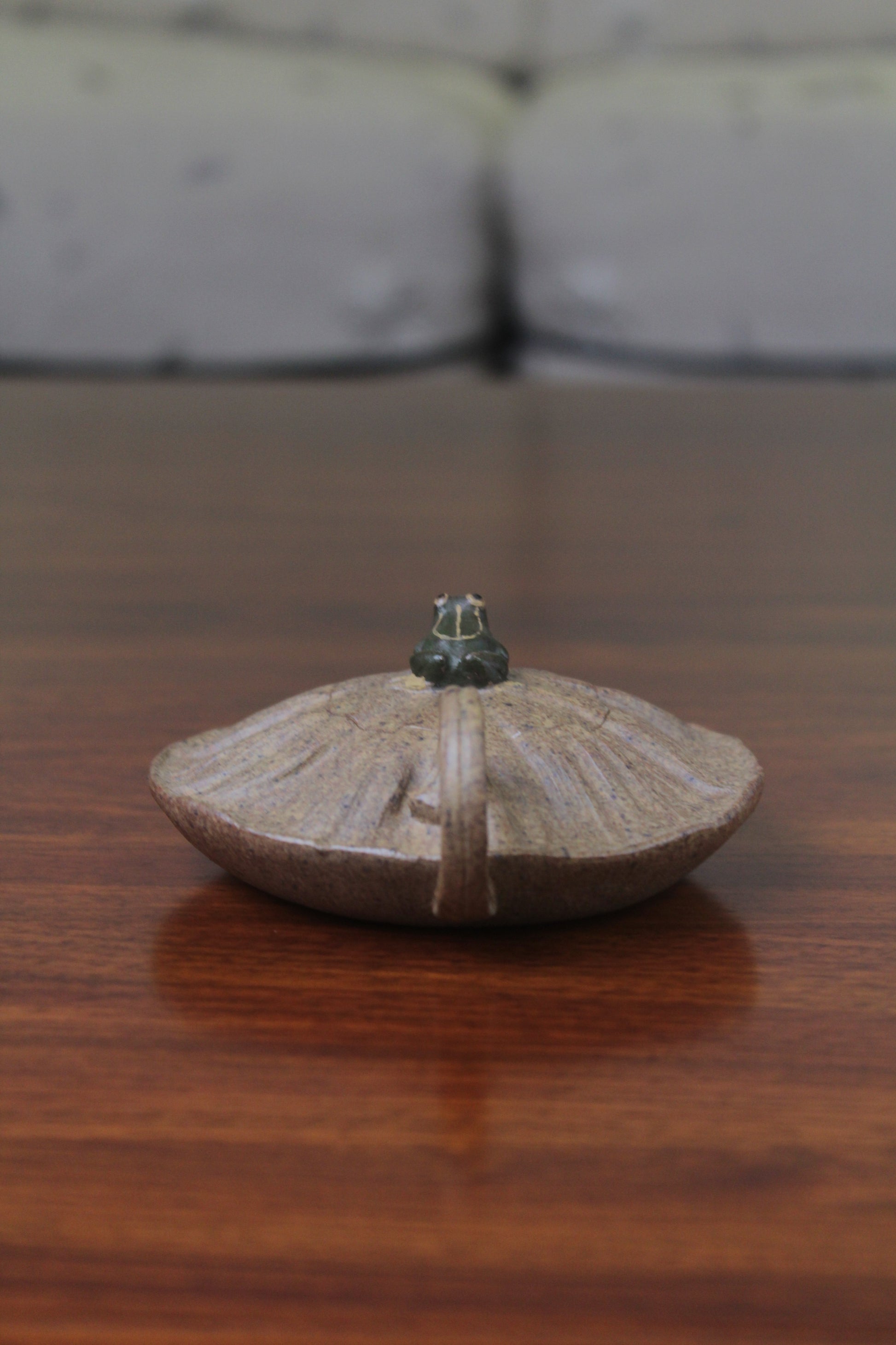 Handle of the yixing clay teapot on the table