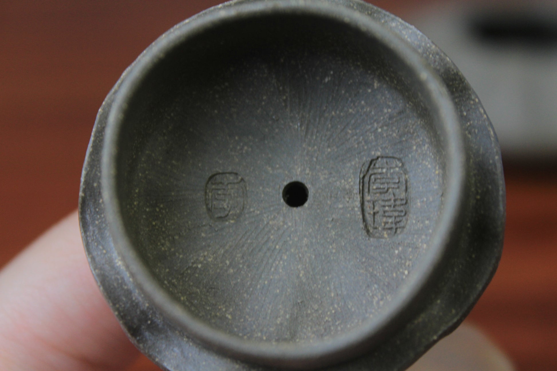 Lid of the yixing clay teapot on the table
