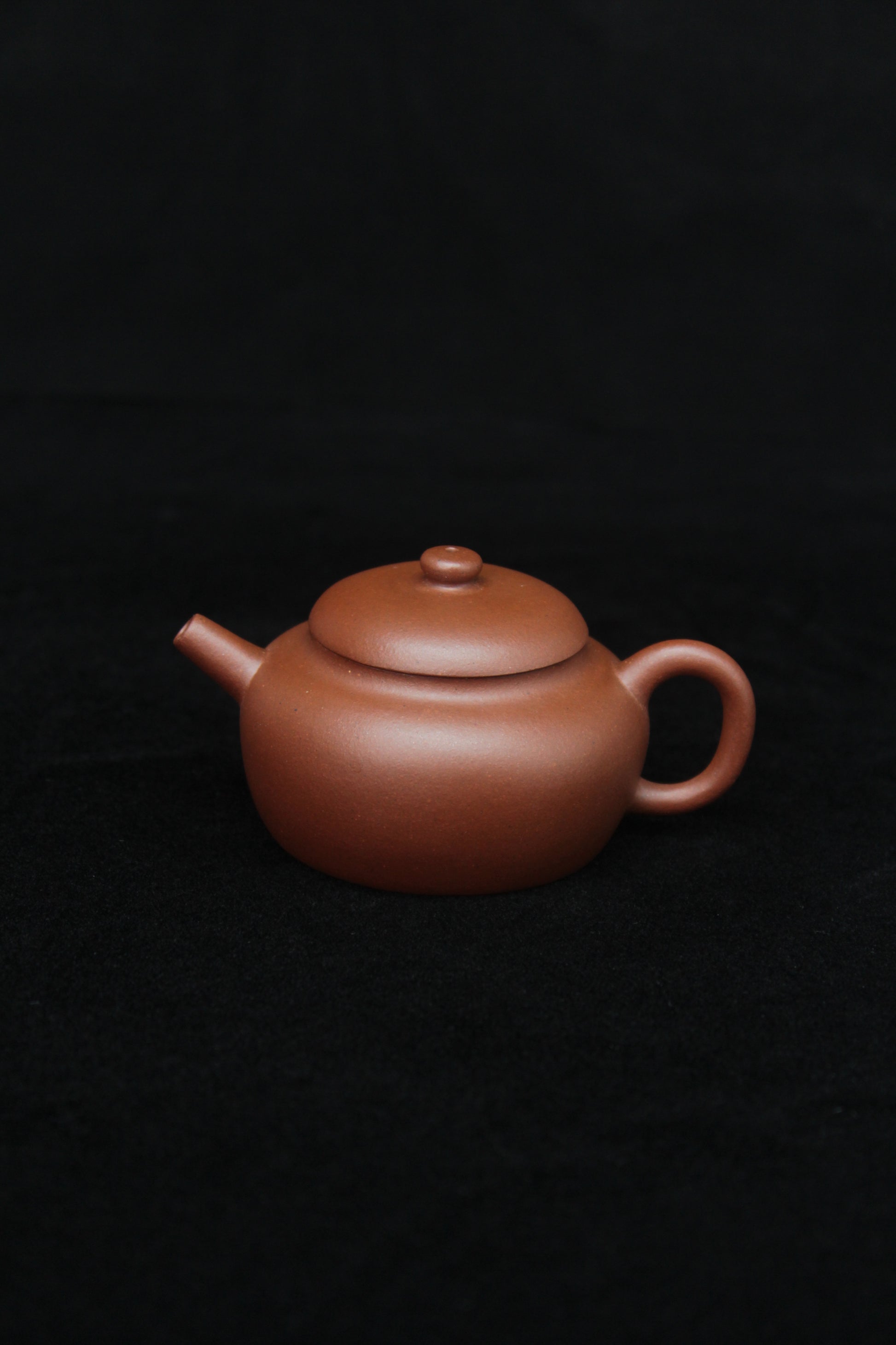 This is a vintage small Yixing teapot made of dicaoqing purple clay