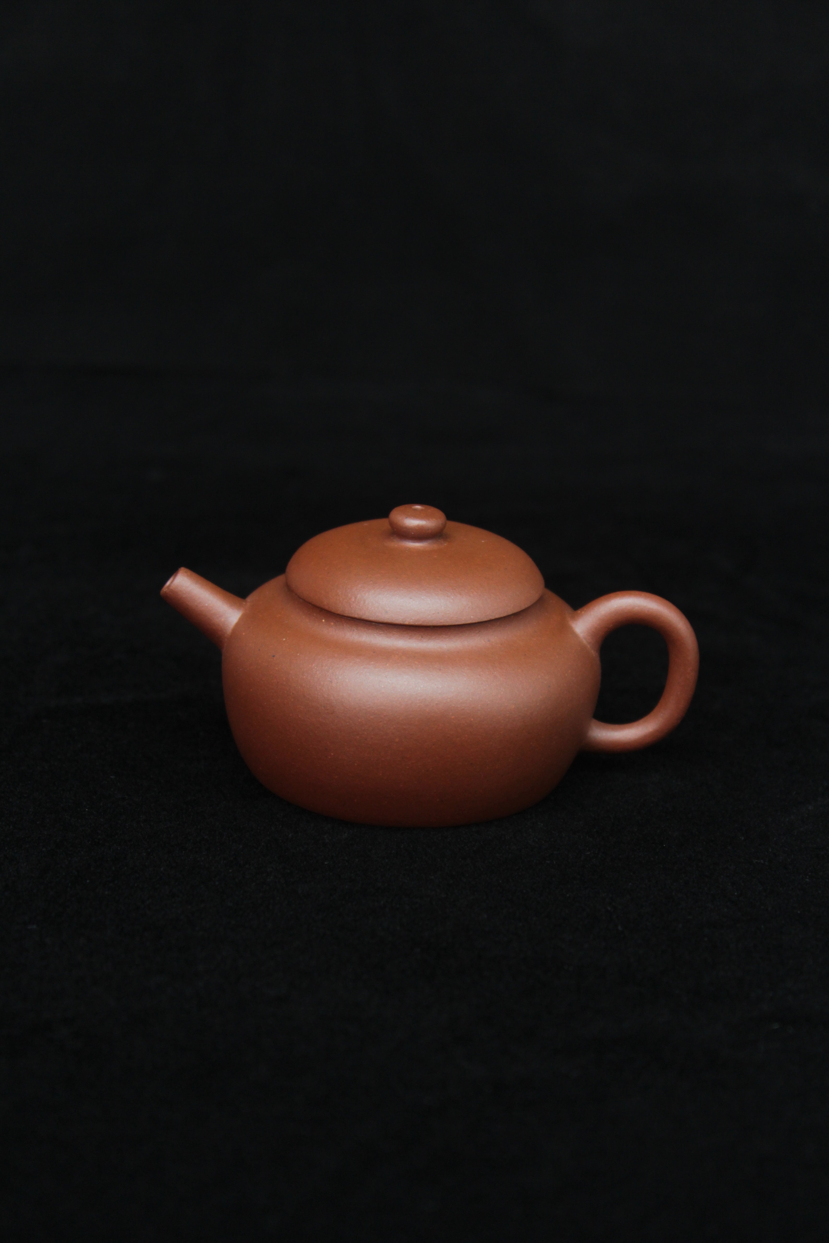 This is a vintage small Yixing teapot made of dicaoqing purple clay