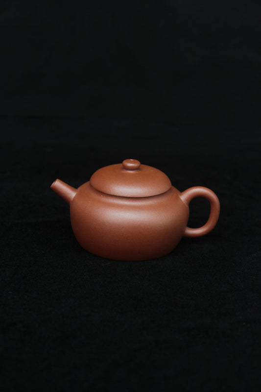 This is a vintage small Yixing teapot made of dicaoqing purple clay